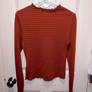 Orange top with accents to the neck and wrists!